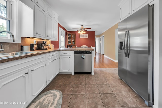 2213 Tanner Bridge Rd, Jefferson City, MO 65101 - kitchen with stainless steel appliances, a peninsula, white cabinetry, and healthy amount of natural light