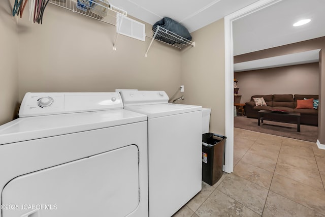2213 Tanner Bridge Rd, Jefferson City, MO 65101 - laundry room featuring independent washer and dryer and light tile patterned floors