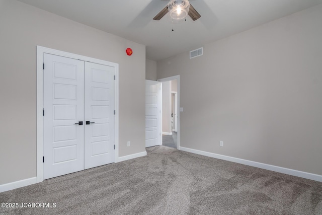 unfurnished bedroom featuring baseboards, visible vents, a closet, and carpet flooring