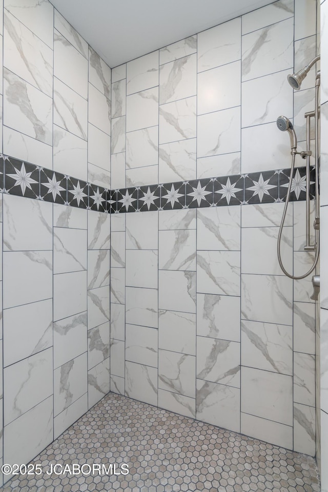 bathroom with a tile shower