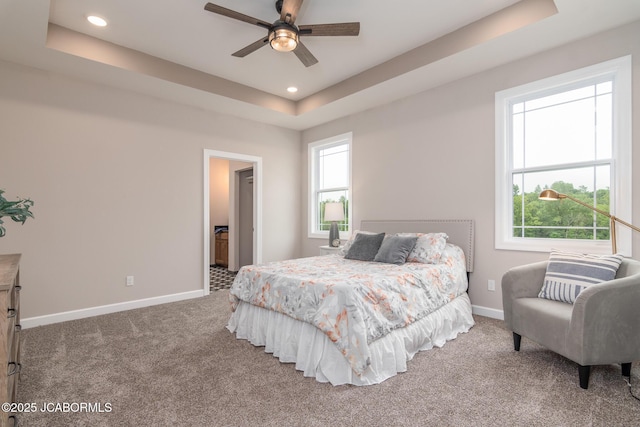 bedroom featuring carpet, baseboards, connected bathroom, recessed lighting, and a tray ceiling