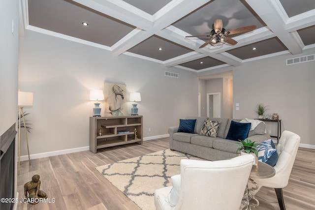 living room featuring baseboards, visible vents, and a ceiling fan