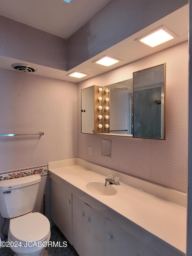 bathroom with tile patterned flooring, vanity, and toilet