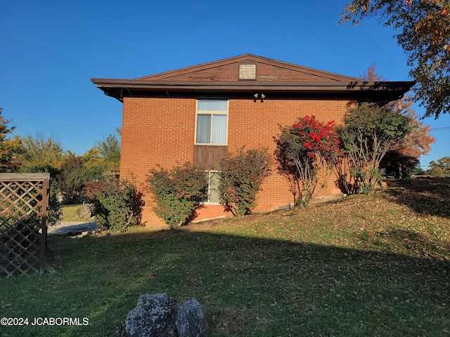 view of home's exterior with a lawn