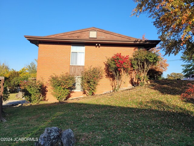 view of home's exterior featuring a lawn