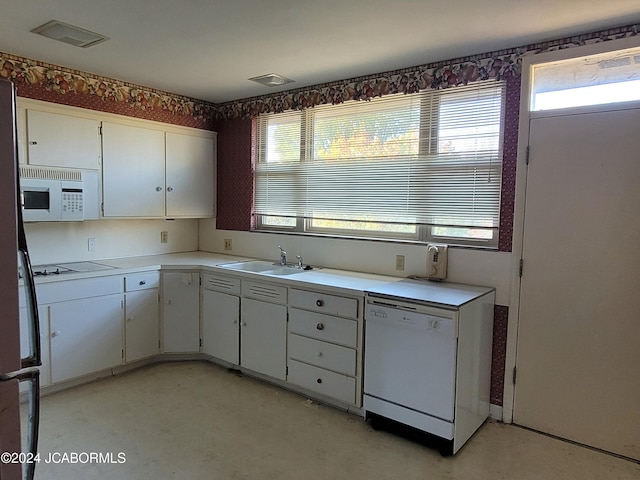 kitchen featuring white cabinetry, white appliances, and sink