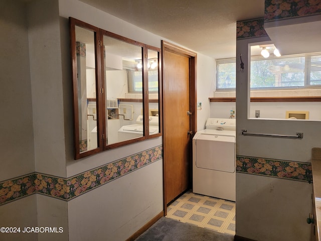 clothes washing area featuring washer / dryer