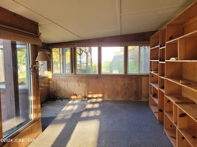 unfurnished sunroom featuring lofted ceiling