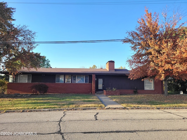 ranch-style home with a front lawn