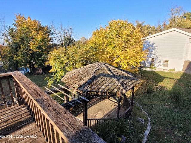 deck featuring a gazebo and a lawn