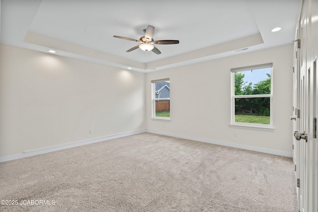 5111 Democracy Dr, Ashland, MO 65010 - spare room featuring a tray ceiling, ceiling fan, recessed lighting, and light carpet
