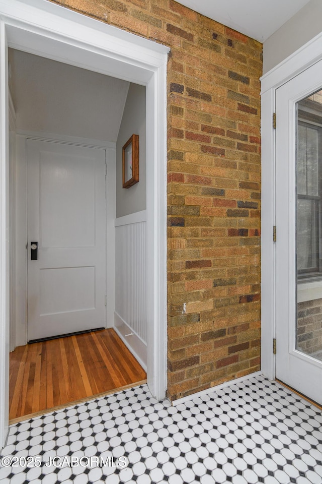 1311 Elmerine Ave, Jefferson City, MO 65101 - corridor with brick wall, wood finished floors, and wainscoting