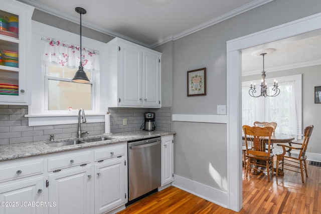 1311 Elmerine Ave, Jefferson City, MO 65101 - kitchen featuring dishwasher, wood finished floors, backsplash, a chandelier, and white cabinetry