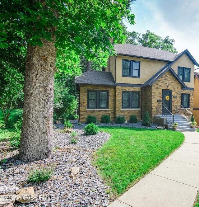 1311 Elmerine Ave, Jefferson City, MO 65101 - view of front of home featuring stucco siding, a front yard, and roof with shingles
