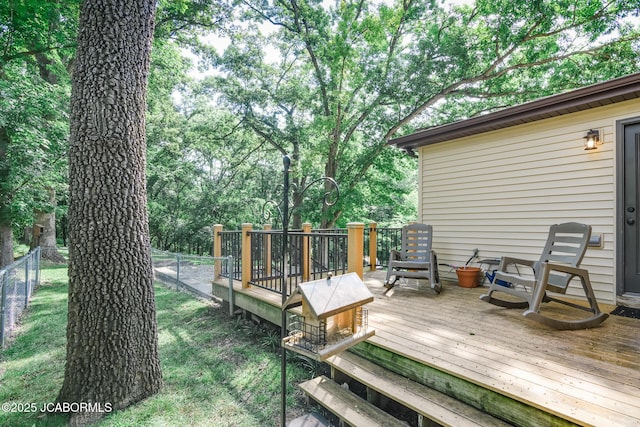 1311 Elmerine Ave, Jefferson City, MO 65101 - deck with a fenced backyard and view of wooded area