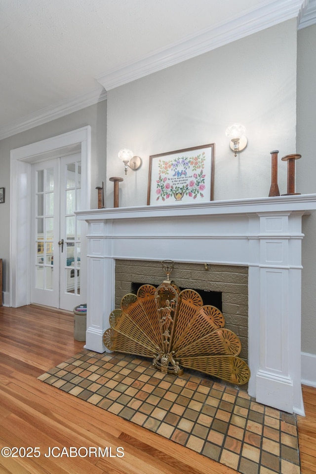 1311 Elmerine Ave, Jefferson City, MO 65101 - detailed view of a fireplace with flush hearth, crown molding, french doors, and wood finished floors