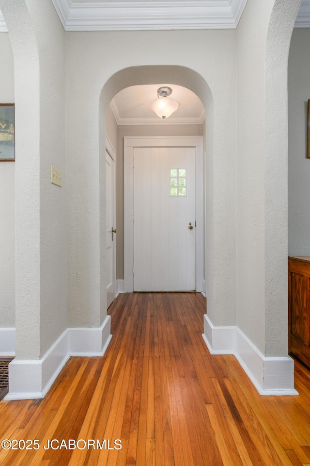 1311 Elmerine Ave, Jefferson City, MO 65101 - entrance foyer with hardwood / wood-style floors, ornamental molding, and arched walkways