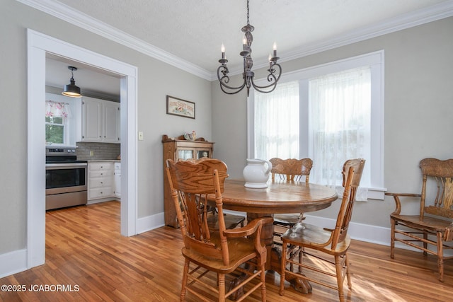 1311 Elmerine Ave, Jefferson City, MO 65101 - dining area with a chandelier, ornamental molding, and light wood-style flooring