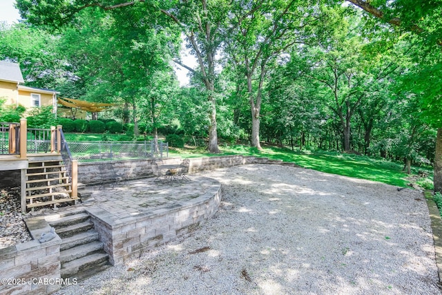 1311 Elmerine Ave, Jefferson City, MO 65101 - view of patio with stairs, a deck, and view of wooded area