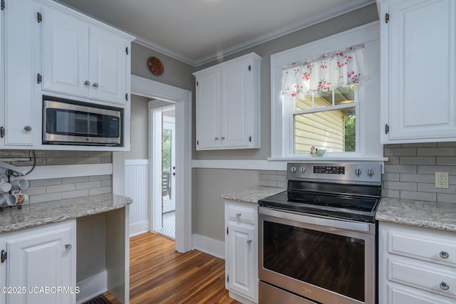 1311 Elmerine Ave, Jefferson City, MO 65101 - kitchen with appliances with stainless steel finishes, tasteful backsplash, white cabinets, dark wood-style flooring, and ornamental molding