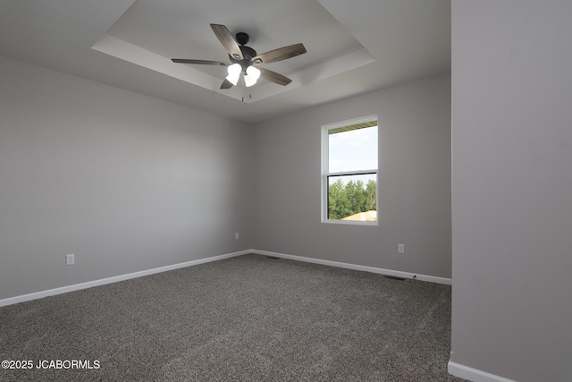 5705 Summerfield Ct, Jefferson City, MO 65109 - spare room with a raised ceiling, a ceiling fan, and carpet