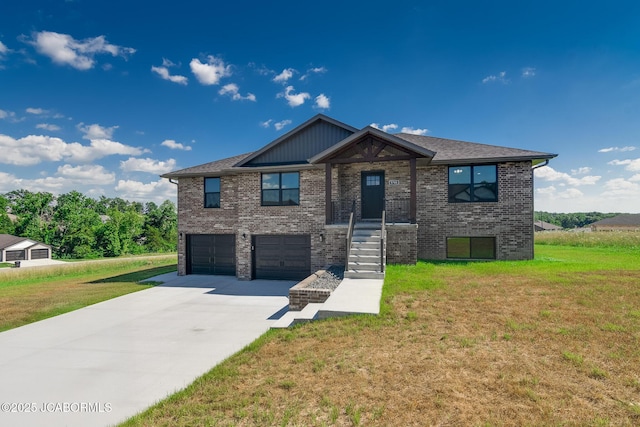 5705 Summerfield Ct, Jefferson City, MO 65109 - view of front of home with an attached garage, driveway, a front lawn, and brick siding