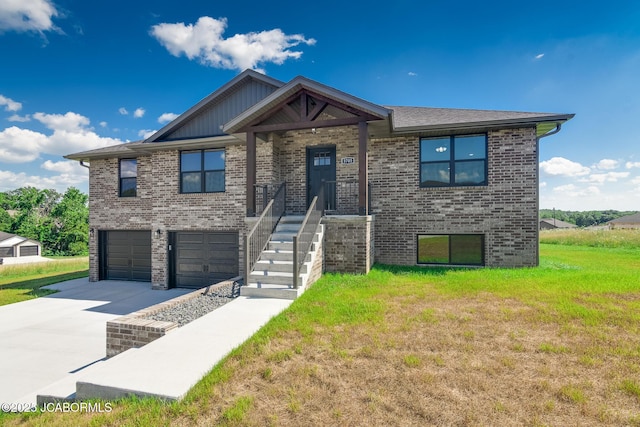 5705 Summerfield Ct, Jefferson City, MO 65109 - view of front of property with a garage, concrete driveway, a front yard, and brick siding