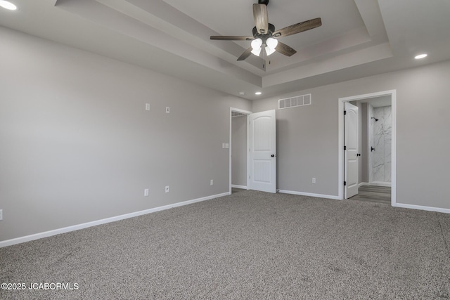 5705 Summerfield Ct, Jefferson City, MO 65109 - unfurnished bedroom featuring recessed lighting, a tray ceiling, carpet flooring, and ensuite bath