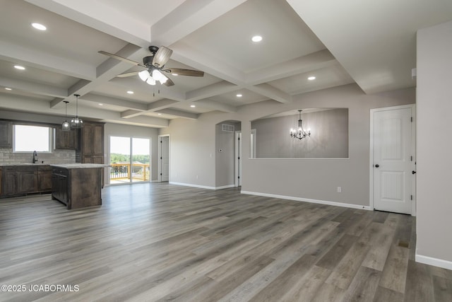 5705 Summerfield Ct, Jefferson City, MO 65109 - unfurnished living room with a chandelier, coffered ceiling, a ceiling fan, wood finished floors, and beam ceiling