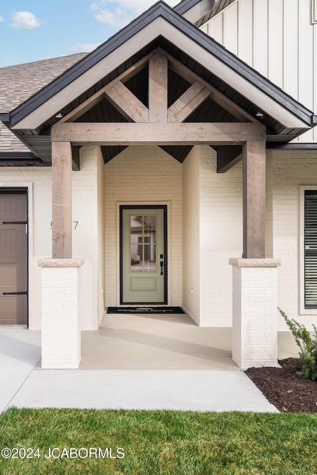 5607 Birch Creek Ln, Jefferson City, MO 65101 - view of exterior entry featuring brick siding and board and batten siding