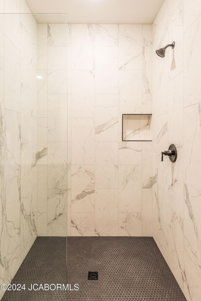 bathroom with tiled shower