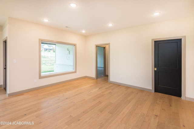 unfurnished room with light hardwood / wood-style floors