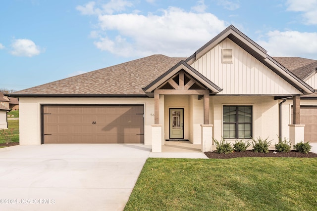 5607 Birch Creek Ln, Jefferson City, MO 65101 - view of front of house featuring an attached garage, a shingled roof, board and batten siding, concrete driveway, and a front yard