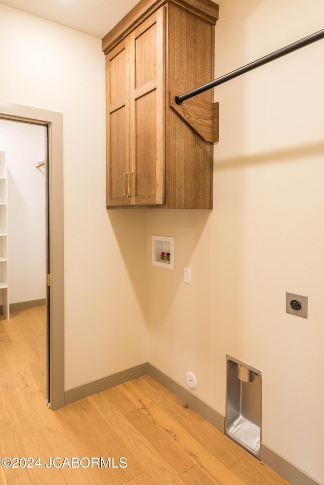 clothes washing area featuring gas dryer hookup, hookup for a washing machine, hookup for an electric dryer, and light wood-type flooring