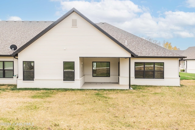 5607 Birch Creek Ln, Jefferson City, MO 65101 - rear view of house with a shingled roof, a patio, a lawn, and brick siding