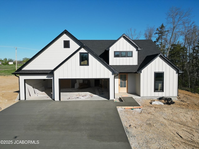 6343 Yellowstone Dr, Ashland, MO 65010 - modern farmhouse with board and batten siding, an attached garage, roof with shingles, and aphalt driveway