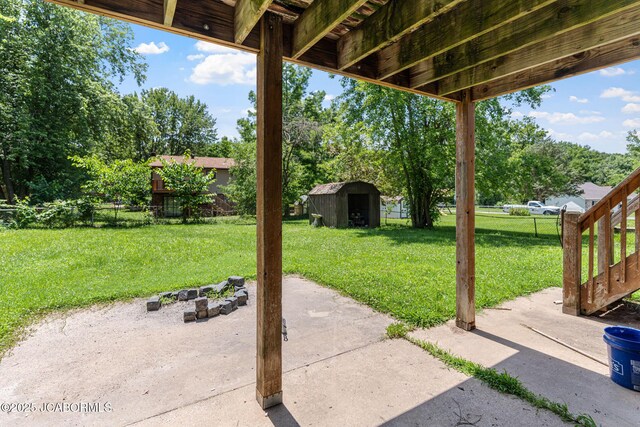 5501 S Brooks Dr, Jefferson City, MO 65109 - view of patio / terrace featuring a storage unit and view of scattered trees