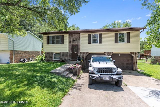5501 S Brooks Dr, Jefferson City, MO 65109 - raised ranch featuring concrete driveway, a front yard, an attached garage, and brick siding