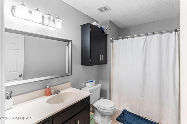 5501 S Brooks Dr, Jefferson City, MO 65109 - full bathroom with vanity, a textured ceiling, curtained shower, and wood finished floors
