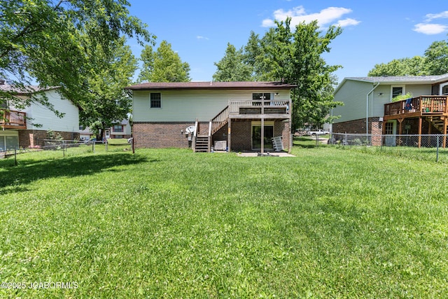 5501 S Brooks Dr, Jefferson City, MO 65109 - back of property with stairway, a deck, a fenced backyard, and brick siding