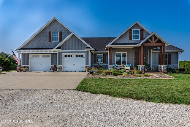 craftsman-style home featuring a front lawn, stone siding, board and batten siding, covered porch, and concrete driveway