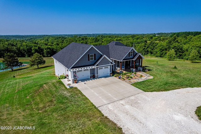 birds eye view of property featuring a view of trees