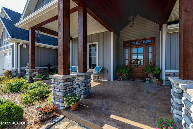 doorway to property with a porch and board and batten siding