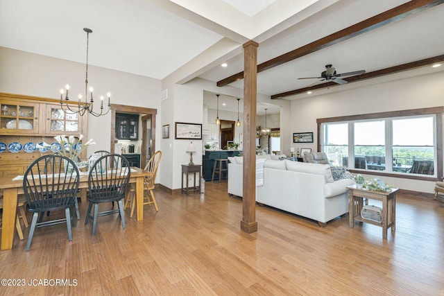 dining area with light wood-type flooring, beam ceiling, ceiling fan with notable chandelier, and ornate columns