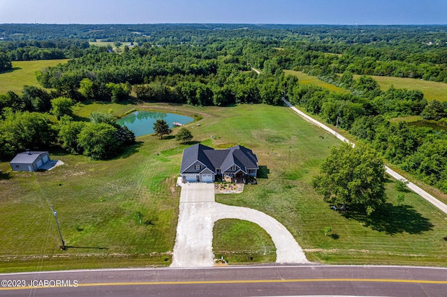 aerial view featuring a rural view, a view of trees, and a water view