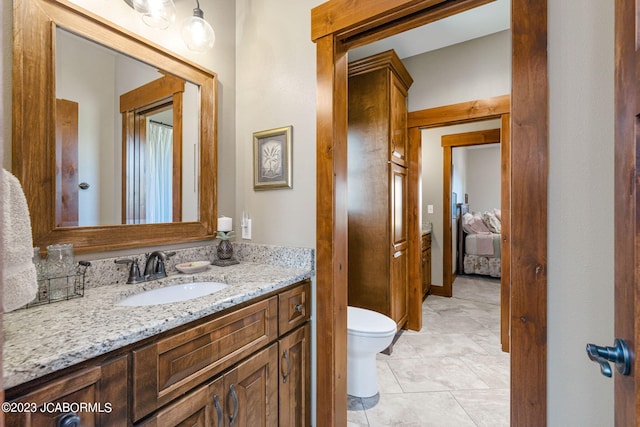 bathroom featuring tile patterned floors, toilet, and vanity