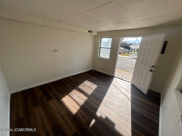 foyer entrance featuring dark hardwood / wood-style flooring and a drop ceiling