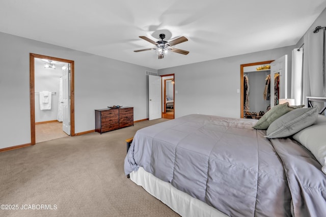 990 Diamond Rdg, Jefferson City, MO 65109 - carpeted bedroom with connected bathroom, ceiling fan, a walk in closet, baseboards, and visible vents