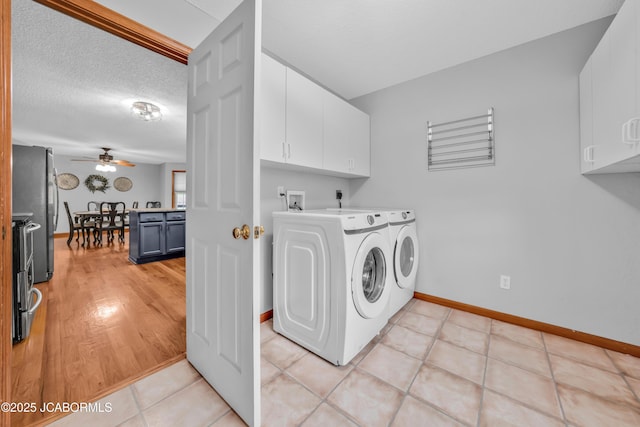 990 Diamond Rdg, Jefferson City, MO 65109 - washroom with ceiling fan, a textured ceiling, washing machine and clothes dryer, cabinet space, and baseboards