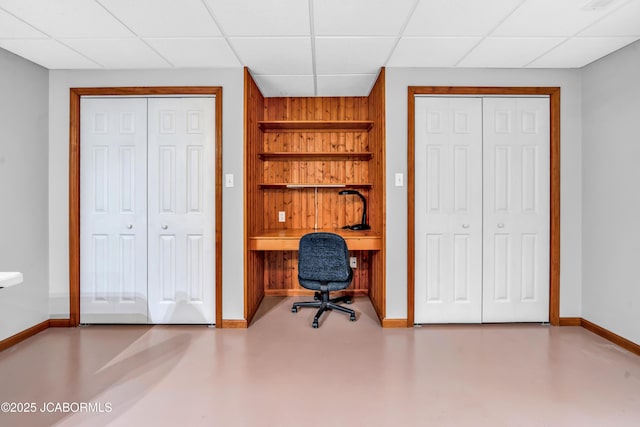 990 Diamond Rdg, Jefferson City, MO 65109 - office area with wooden walls, concrete floors, built in features, a paneled ceiling, and baseboards